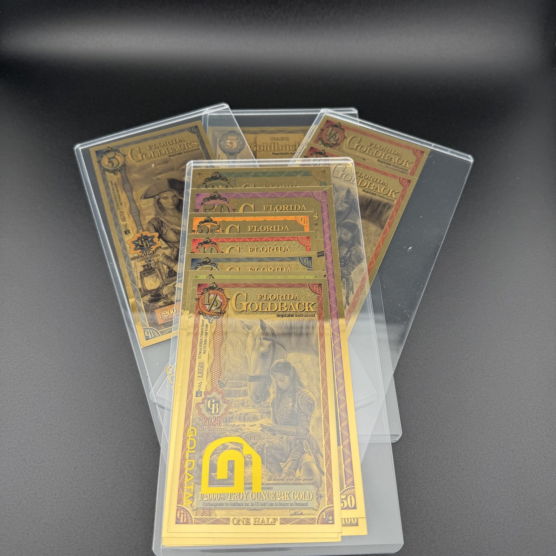 Multiple Goldback PVC Bill Holders fanned out, each holding a stack of Goldback notes