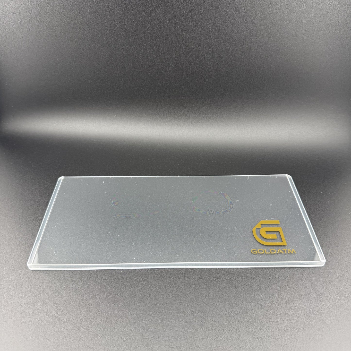 Empty Goldback PVC Bill Holder laid flat showing the crystal-clear rigid PVC and gold GoldATM logo