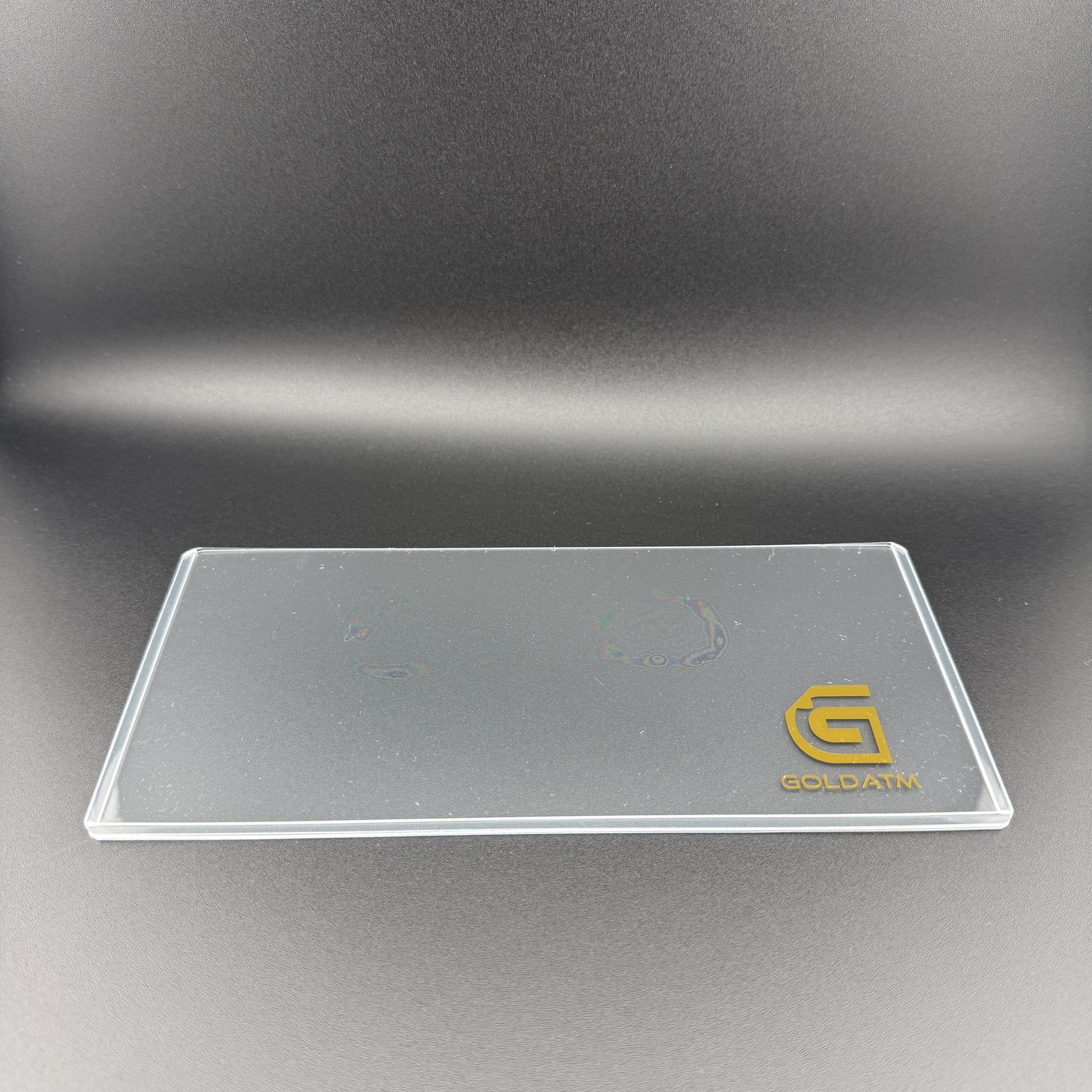 Empty Goldback PVC Bill Holder laid flat showing the crystal-clear rigid PVC and gold GoldATM logo
